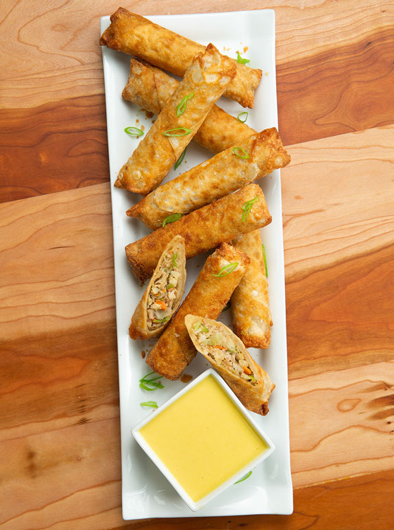 Jet’s Honey Mustard Dipping Sauce in a dish next to baked Pagoda® Egg Rolls