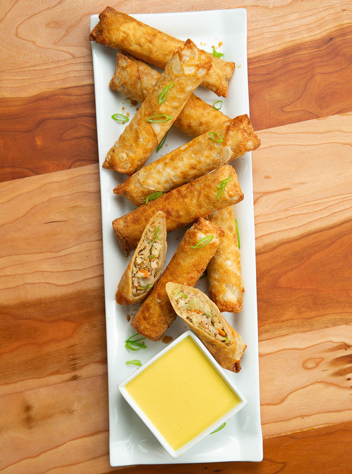 Jet’s Honey Mustard Dipping Sauce in a dish next to baked Pagoda® Egg Rolls