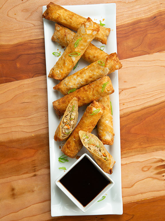 PAGODA's Not-So-Secret Dipping Sauce in a dish next to baked Pagoda® Egg Rolls