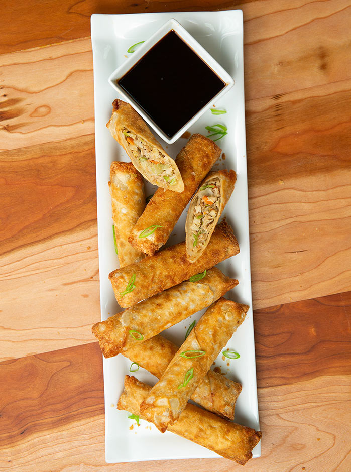 PAGODA's Not-So-Secret Dipping Sauce in a dish next to baked Pagoda® Egg Rolls